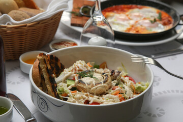 Various Mediterranean dishes and wines served on the restaurant table	