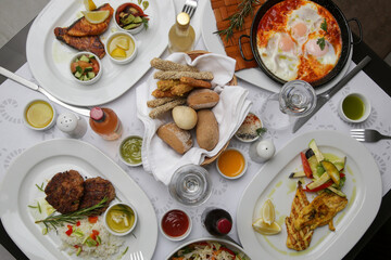 Various Mediterranean dishes and wines served on the restaurant table