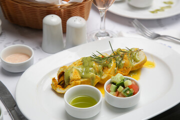 Stuffed chicken rolls served with sauce and vegetables on the resturant table