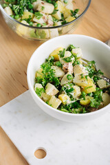 Potato salad with tuna and green peas.