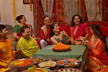 Happy family in traditional outfit celebrating Diwali together at home