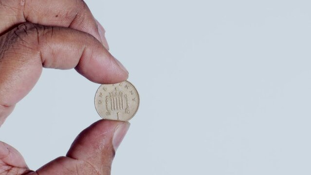 Hand Holding 1 Penny Back