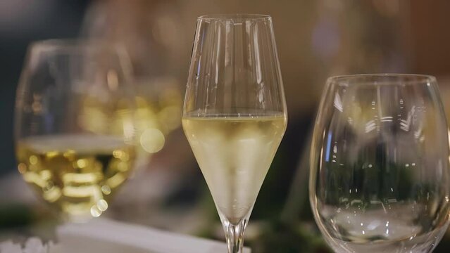 The wine is poured into glasses that stand on a beautiful festive table. Very nice close-up