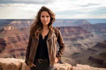 Wandaufkleber Lifestyle portrait photography of a cheerful girl in her 20s frowning sporting a stylish leather blazer at the grand canyon in arizona usa. With generative AI technology © Markus Schröder
