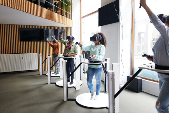 Diverse teenage friends using vr gear