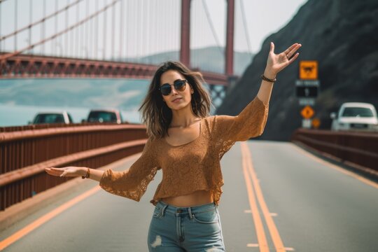 Medium shot portrait photography of a jovial girl in her 20s making a stop sign with hand showing off a cute crop top at the golden gate bridge in san francisco usa. With generative AI technology