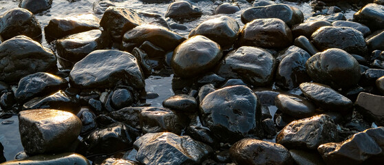 black stones on the beach, rocks on the beach, rocks on the coast, sunset on the beach, rocks and sea, close up of a lot of stones