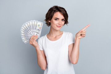 Photo of confident pretty lady wear white t-shirt showing rising cash fan showing empty space...