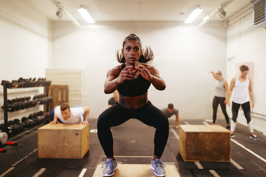 Fit woman doing box jumps during her gym workout