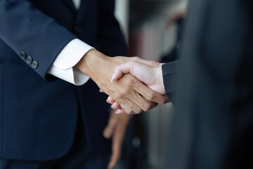 Closeup Handshake of employees after successful planning strategy marketing in the office