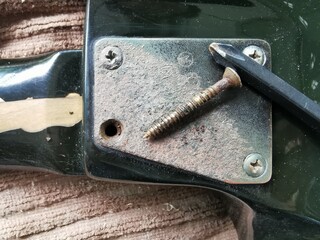 Remove the old guitar neck plate for repairs