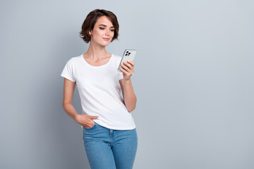 Photo of lovely positive girl hodl use smart phone write typing blog post empty space ad isolated...