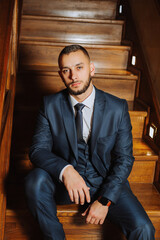 elegant groom with a beard in a beautiful blue jacket and white shirt. Businessman in classic...