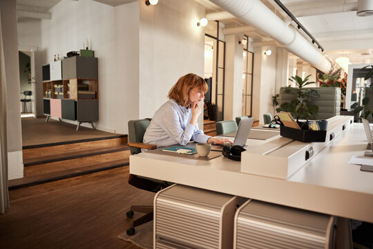 Young businesswoman working late in an office