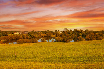 A large pond in the field at sunset