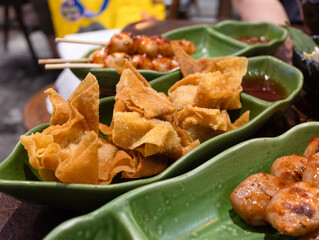 Deep fried crispy wonton or fried wrapper with its sauce. Wonton are a popular Chinese dish. The wonton wrappers are filled with either vegetables, meat or shrimp, then deep-fried until turn golden.