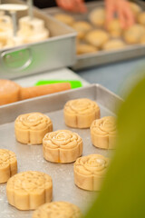 Mooncake making process. A mooncake  is a Chinese bakery product traditionally eaten during the Mid-Autumn Festival.