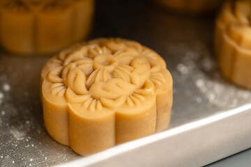 Mooncake making process. A mooncake  is a Chinese bakery product traditionally eaten during the Mid-Autumn Festival.