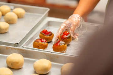 Mooncake making process. A mooncake  is a Chinese bakery product traditionally eaten during the Mid-Autumn Festival.