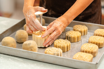Mooncake making process. A mooncake  is a Chinese bakery product traditionally eaten during the Mid-Autumn Festival.