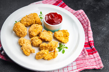 chicken nuggets tomato sauce deep-fried meat ready to eat healthy meal food snack on the table copy space food background rustic top view