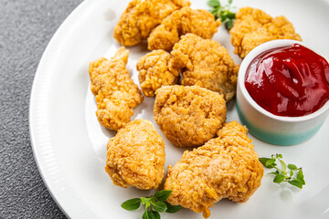 chicken nuggets tomato sauce deep-fried meat ready to eat healthy meal food snack on the table copy space food background rustic top view