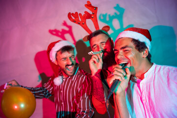 Guys having fun singing karaoke at New Year Eve party