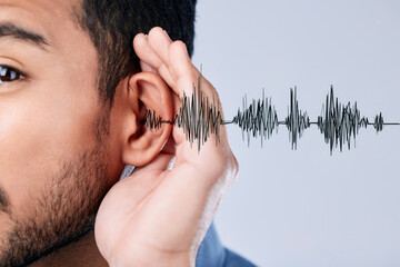 Ear, listening and sound waves with a hand on a studio background for communication, gossip or...