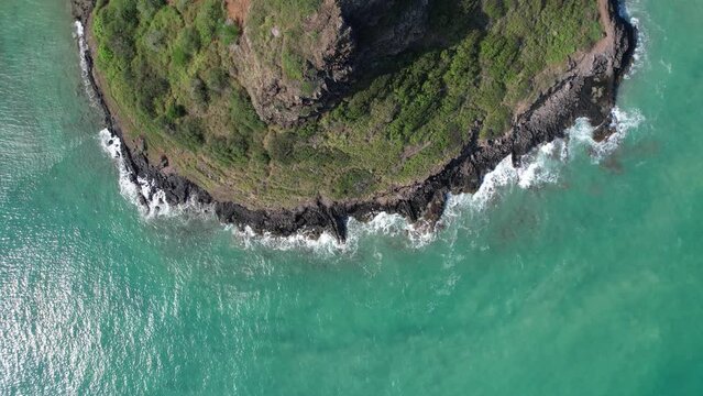 Direct overhead view of Chinaman's Hat, officially Mokolii Island, on the east coast of Oahu, Hawaii - 4k aerial drone video