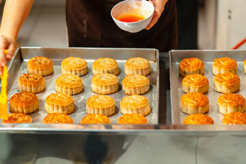 Mooncake making process. A mooncake  is a Chinese bakery product traditionally eaten during the Mid-Autumn Festival.