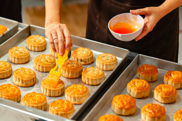 Mooncake making process. A mooncake  is a Chinese bakery product traditionally eaten during the Mid-Autumn Festival.