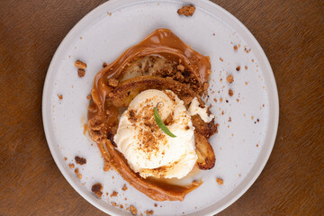 banoffee dessert with banana dulce de leche vanilla ice cream and ground biscuit top view