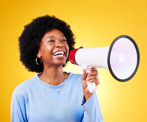 Happy black woman, megaphone and voice in promotion, advertising or marketing on a yellow studio...