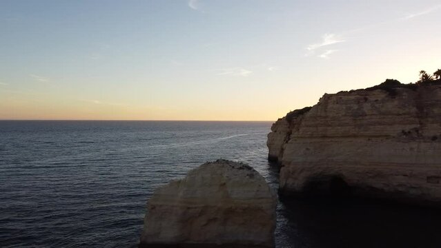 Left Pan Rocks and Water Drone View Looking out at the Ocean. Skyline, ocean, and rocky cliffs. Shoreline of Portugal.