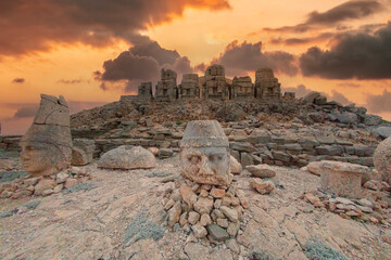 The ancient carved heads of Zeus, Apollo, Hercules and lion at sunset on the east terrace at Mount Nemrut (Nemrut Dağı) an archaeological site of the ancient Kingdom of Commagene in south east Turkey