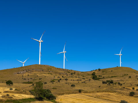 Aerial view of wind turbines and agriculture field