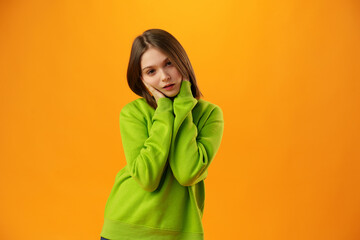 Upset disturbed teen girl on yellow background