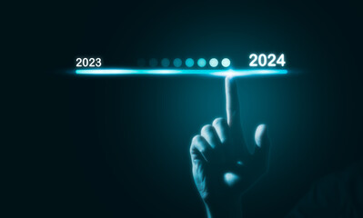 2024 business planning and strategy concept, Hand touching on download bar status to change from 2023 to 2024 for countdown of merry Christmas and happy new year by technology concept, 2024 trend
