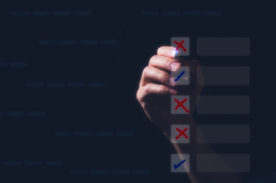 Businessman using pen tick mark and cross in checkbox for quality document control checklist and business approve project concept. Successful completion of business tasks. management goal strategy