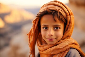 Close-up portrait photography of a joyful boy in his 30s wearing an elegant silk scarf at the petra in maan jordan. With generative AI technology