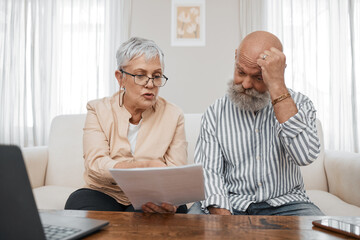 Budget, documents and senior couple with stress planning financial investments, mortgage or tax papers. Elderly woman speaking of bills, debt and pension fund on bank statement to an old man at home