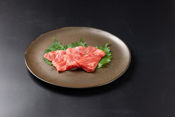 Rare Sliced Wagyu beef with marbled texture. Japanese and korean rare beef for grilled on black plate food isolated on gray stone banner background