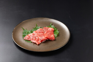 Rare Sliced Wagyu beef with marbled texture. Japanese and korean rare beef for grilled on black plate food isolated on gray stone banner background