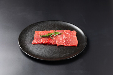 Rare Sliced Wagyu beef with marbled texture. Japanese and korean rare beef for grilled on black...