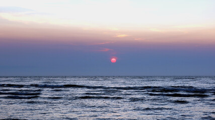 Scenic sunset over the sea. Poland seaside, Leba village and beach. Seascape - obrazy, fototapety, plakaty