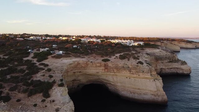 Slow Ascending Aerial View of Ocean Coast, Campground, & Lagoa City in Portugal. Up from seawater landscape drone shot.