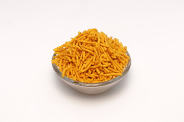 Close up of Spicy Aloo Bhujia on a transparent bowl, made with Red chili, Potatoes, and Chickpeas. Indian spicy snacks (Namkeen),  side view 