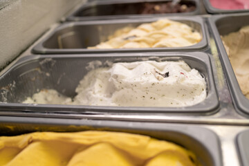 Italian ice cream on display in a store, a variety of flavors