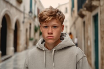 Obraz premium Close-up portrait photography of a glad boy in his 20s wearing a comfy fleece pullover at the dubrovnik old town in dubrovnik croatia. With generative AI technology