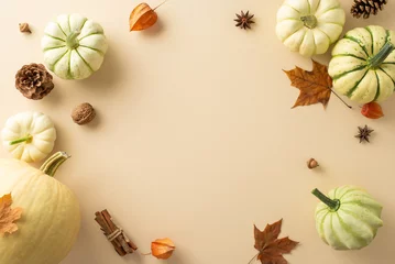 Zelfklevend Fotobehang Transport yourself to the fall harvest ambiance with this top-down capture. Ripped pumpkins and iconic autumnal elements showcased on a neutral beige background, inviting text or advertisements © ActionGP